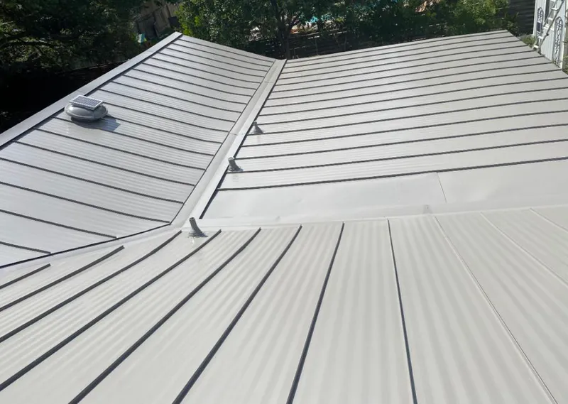 Solar attic fan installed on a metal roof for Roof Ventilation in Madison